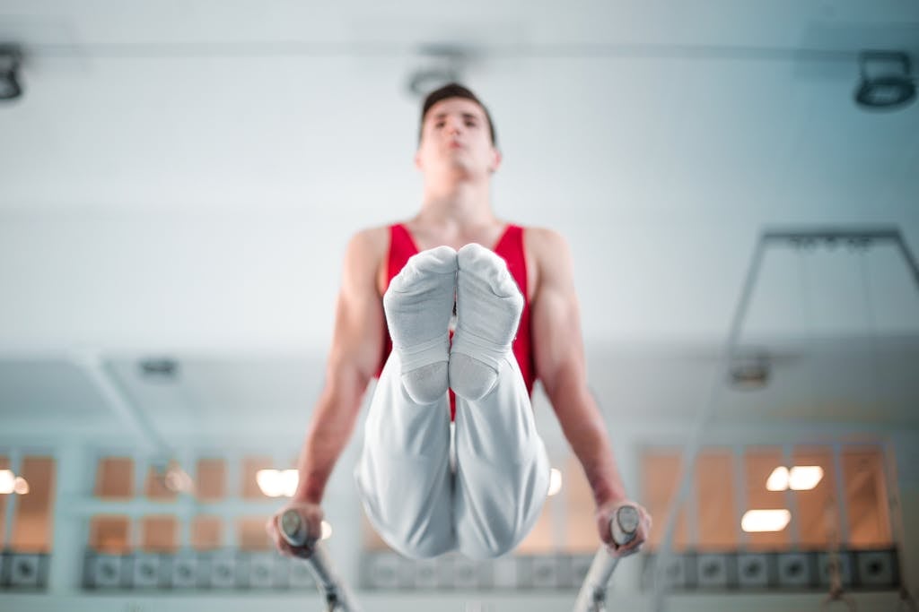 Selective Focus Photo of Male Gymnast Practicing in Gym