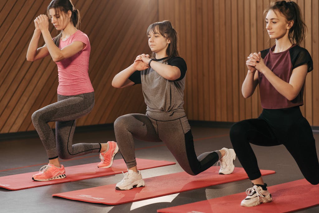 Three Women In Activewear Doing Leg Exercise