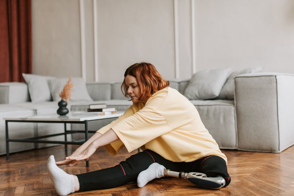 Woman doing an Excercise while sitting on the Floor