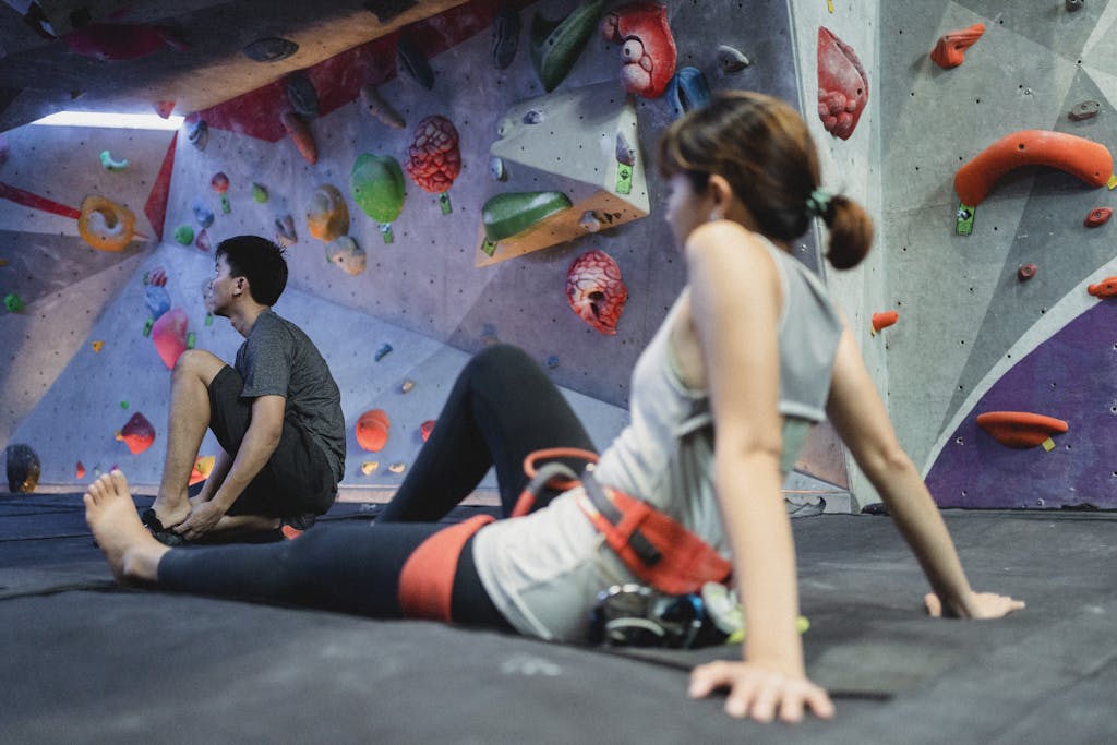 Young woman and man preparing for climbing training